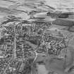 Oblique aerial view of Leslie centred on the village housing development designed by Wheeler and Sproson in 1952-56, and recorded as part of the Wheeler and Sproson Project.  Taken from the NE.