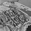 Oblique aerial view of Burntisland centred on the Somerville Square and Somerville Street housing redevelopments designed by Wheeler and Sproson in 1955-62 and recorded as part of the Wheeler and Sproson Project and a Threatened Building Survey completed in 2001.  Taken from the WNW.