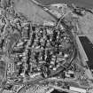 Oblique aerial view of Burntisland centred on the Somerville Square and Somerville Street housing redevelopments designed by Wheeler and Sproson in 1955-62 and recorded as part of the Wheeler and Sproson Project and a Threatened Building Survey completed in 2001.  Taken from the W.