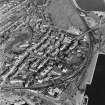 Oblique aerial view of Burntisland centred on the Somerville Square and Somerville Street housing redevelopments designed by Wheeler and Sproson in 1955-62 and recorded as part of the Wheeler and Sproson Project and a Threatened Building Survey completed in 2001.  Taken from the SW.