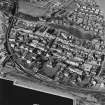 Oblique aerial view of Burntisland centred on the Somerville Square and Somerville Street housing redevelopments designed by Wheeler and Sproson in 1955-62 and recorded as part of the Wheeler and Sproson Project and a Threatened Building Survey completed in 2001.  Taken from the SE.