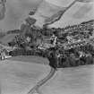 Oblique aerial view centred on the village of Auchtertool with house adjacent, taken from the WSW.