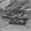 Oblique aerial view centred on the village of Auchtertool with house adjacent, taken from the SW.