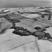 Oblique aerial view looking across house, walled garden, farmsteading and farmhouse towards Kirkcaldy, taken from the NNW.