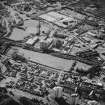 Oblique aerial view centred on the site of the works with the engineering works, foundry and offices, factory and works adjacent, taken from the SE.