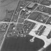 Oblique aerial view of Crail Airfield centred on the remains of buildings, huts and aircraft hangars, taken from the S.