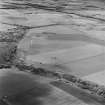 Oblique aerial view of Dunino Airfield centred on the remains of buildings and a control tower, taken from the ESE.