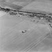 Oblique aerial view of Dunino Airfield centred on the remains of the control tower, taken from the WNW.
