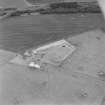 Oblique aerial view of Troy Wood centred on the radar station and military headquarters, taken from the SSW.