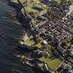 Oblique aerial view centred on the remains of the castle, taken from the NW.