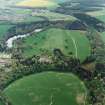 Oblique aerial view centred on Fyvie Castle and policies, with walled garden adjacent, taken from the N.