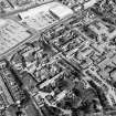 Oblique aerial view centred on the hospital, obelisk, factory and mill, taken from the W.