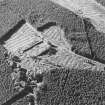 Oblique aerial view of Auchernoch centred on the remains of a country house and its grounds including a mill building, taken from the E.