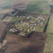Oblique aerial view centred on the hospital with the farmhouse and farmsteading adjacent, taken from the S.
