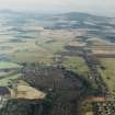 General oblique aerial view looking across the Howe of Alford down the S bank of the River Don towards Cairn William, taken from the WNW.