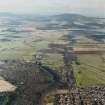 General oblique aerial view looking across the Howe of Alford down the S bank of the River Don towards Cairn William, taken from the WNW.