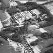 Oblique aerial view centred on the country house and garden, taken from the NW.