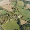 Oblique aerial view centred on the country house and farmsteading with walled garden adjacent, taken from the NW.