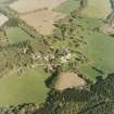 Oblique aerial view centred on the country house and farmsteading with walled garden adjacent, taken from the NW.