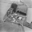 General oblique aerial view centred on the farmstead with the disused quarry adjacent, taken from the NE.