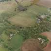 Oblique aerial view of the ruins of the Country House with the Home Farm adjacent, taken from the SW.