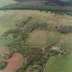 Oblique aerial view centred on the Home Farm with the ruins of the Country House adjacent, taken from the SSE.