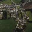 Oblique aerial view of Rhynie centred on the church, taken from the NW.