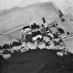 Oblique aerial view centred on Arbuthnott Parish Church, burial-ground and manse, taken from the SW.