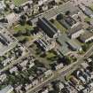 Oblique aerial view centred on the college with the church adjacent, taken from the W.