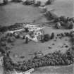 Oblique aerial view centred on the country house during renovation and the remains of the laundry, taken from the WNW.
