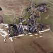 Oblique aerial view centred on the whisky distillery, taken from the WNW.