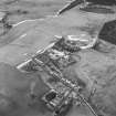 Oblique aerial view centred on the whisky distillery, taken from the SSE.