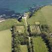 Aerial view of Dunbeath Castle and walled gardens from NW.