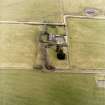 Oblique aerial view centred on the farmsteading and manse, taken from the N.