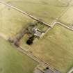 Oblique aerial view centred on the farmsteading and manse, taken from the NW.