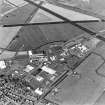 Oblique aerial view of part of Wick Airport, (formerly RAF Wick), taken from the SE. Visible are the two remaining World War Two type 'C' hangars and the present airport terminal buildings.