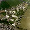 Oblique aerial view of Wick Airport, (formerly RAF Wick), terminal buildings and the two remaining World War Two aircraft hangars, taken from the S.
