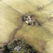 Oblique aerial view centred on the farmsteading with the country house adjacent, taken from the E.
