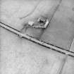 Oblique aerial view centred on the farmsteading, taken from the NE.