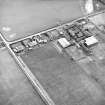 Oblique aerial view centred on the farmsteading, taken from the NNE