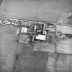 Oblique aerial view centred on the farmsteading, taken from the N