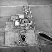 Oblique aerial view centred on the farmsteading, taken from the W