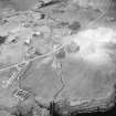 Oblique aerial view centred on the watermill with the house, curing yard, farmsteads and council houses adjacent, taken from the SSE.