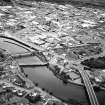 General oblique aerial view of the town, centred on the road bridges and sawmill, taken from the WSW.