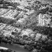 General oblique aerial view of the town, centred on the house, taken from the W.