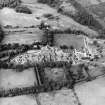 Oblique aerial view centred on the hospital and churches, with the farmsteading adjacent, taken from the ESE.