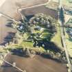 Oblique aerial view centred on the country house, farmhouse and stables taken from the WNW.