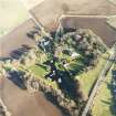 Oblique aerial view centred on the country house, farmhouse and stables taken from the W.