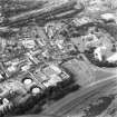 Aerial view of Canongate, also showing Regent Terrace at top of photograph, Holyrood Palace and Abbey to right, Holyrood Road, Meadow Flat Gas Holder Station at bottom, and Canongate heading to left