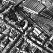 Aerial view showing Canongate and High Street running across middle of photograph, Waverley Station at top, New Street to right, St Mary's Street at bottom and North Bridge to left
